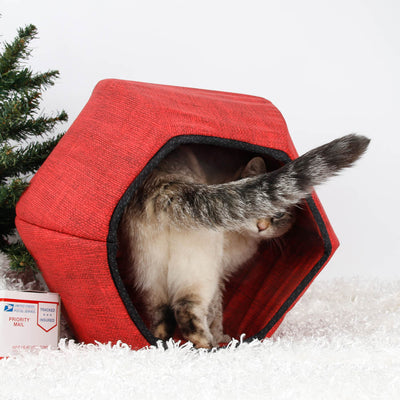 Give your cat an authorized spot under the Christmas tree with a holiday Cat Ball® cat bed! Made with red cotton fabric that looks like burlap and trimmed with black, our innovative cat cave is loved by cats around the world, and makes a great present for cats and cat lovers; made in the USA. 
